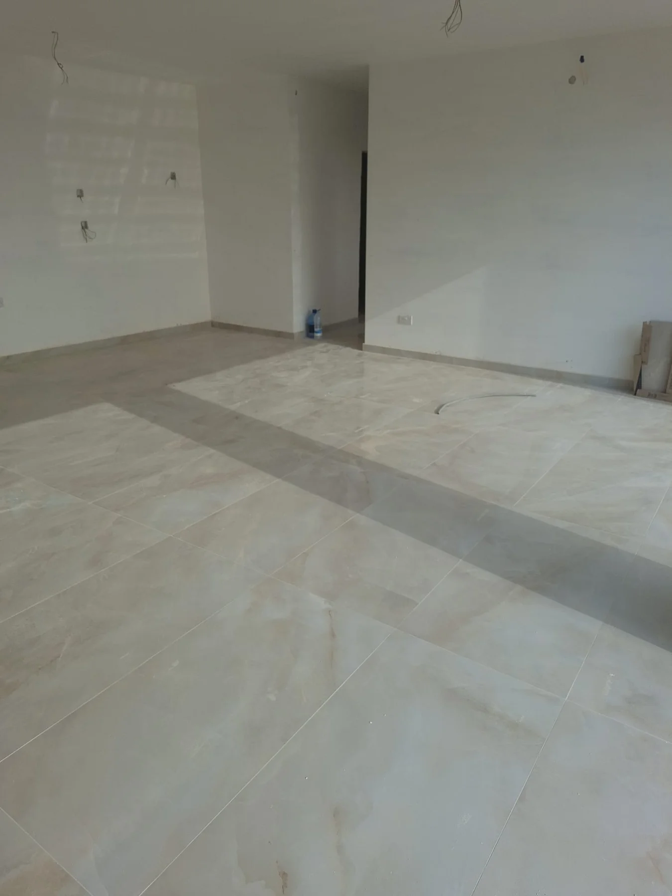 Large format porcelain floor tiles laid in a Gozo living room